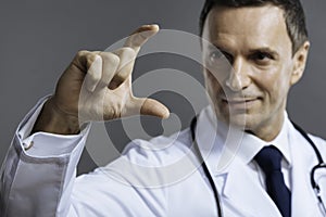 Delighted doctor showing gesture with his hand