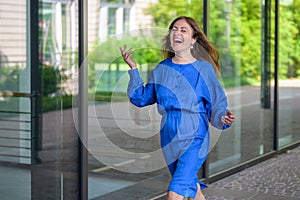 Delighted enthusiastic woman walking happy