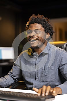 Delighted gamer laughing after finally defeating all enemies while playing on computer