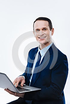 Delighted happy businessman looking at you