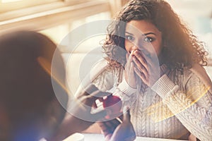 Delighted happy woman looking at the engagement ring