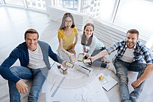 Delighted joyful people holding their smartphones