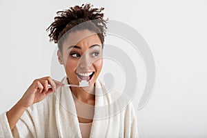 Delighted lady washing teeth in the morning