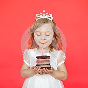 Delighted little girl blowing the candles