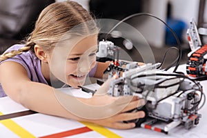 Delighted little pupil exploring new technologies at school