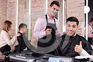 Delighted male client after haircut in salon