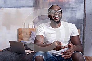 Delighted man watching TV in bedroom