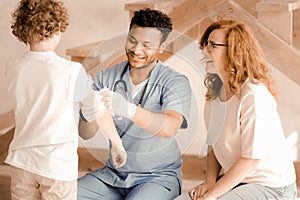 Delighted medical worker dressing wound