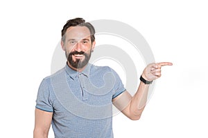 Delighted middle aged man in casual clothes pointing sideways