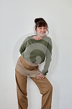 Delighted middle aged woman in trendy clothes