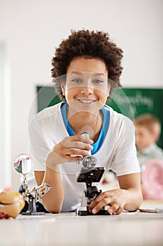 Delighted nice boy studying at school