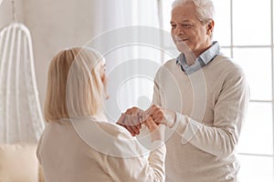 Delighted nice man spending time with his wife