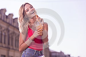 Delighted nice woman enjoying her tasty drink