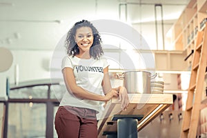 Delighted nice woman standing in the kitchen