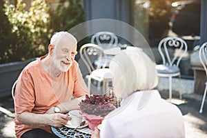 Delighted old man having date with woman