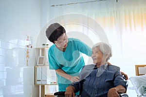 Delighted positive caregiver helping her patient, Nurse hugging