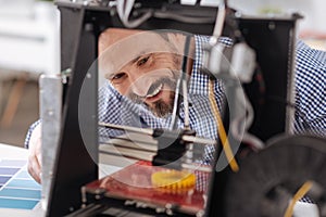 Delighted positive man being happy about the result of his work