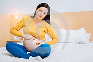 Delighted pregnancy feeling movements of her baby