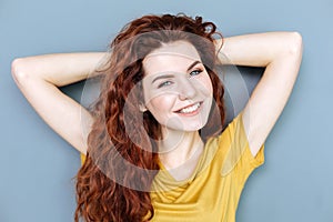 Delighted relaxed woman smiling to you