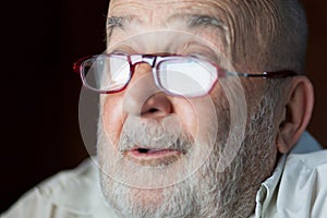 Happy senior man looking at computer screen