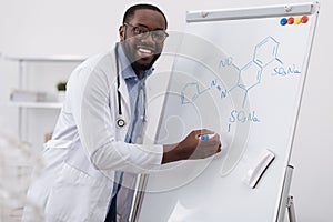 Delighted smart man studying organic chemistry