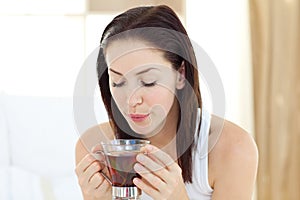 Delighted woman drinking tea