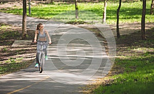 Delighted woman is having bike trip among trees