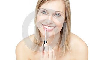 Delighted woman putting gloss
