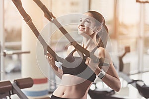 Delighted woman training hard in a gym