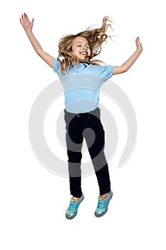 Delighted young girl jumping high in the air