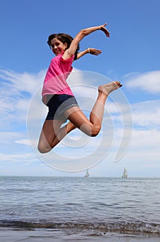 Delighted young girl with short shorts and purple t-shirt doing