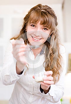 Delighted young mother feeding her baby at home