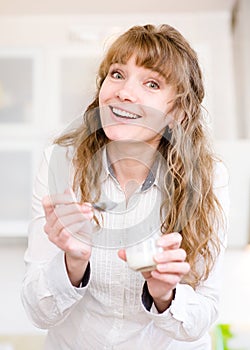 Delighted young mother feeding her baby at home