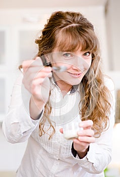 Delighted young mother feeding her baby at home