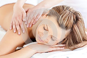 Delighted young woman having a back massage