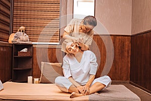 Delighted young woman sitting on the mat