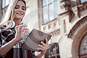 Delighted young woman using a tablet