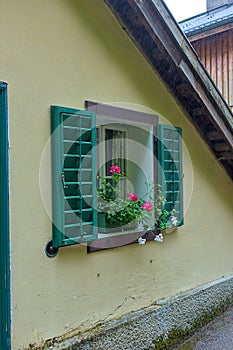 Delightful floral decoration in front of a window in a village house.