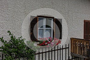 Delightful floral decoration in front of a window in a village house.