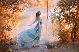 Delightful light girl in sky blue turquoise dress with long flying train