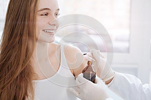 Delightful teenager consulting dermatologist in the clinic