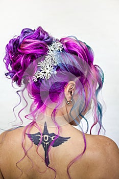 Delightfully bright colored hair, multi-colored coloring on long hair. An elegant high hairstyle