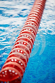 The delimiter is hard lanes in the pool.Red plastic. Swimmers, competitions, track