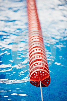 The delimiter is hard lanes in the pool.Red plastic. Swimmers, competitions, track