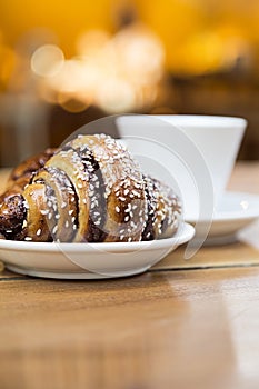 Delish chocolate croissant like rugelach and a cup of coffee in a restaurant