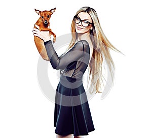 Delited young woman with her little puppy isolated over white ba