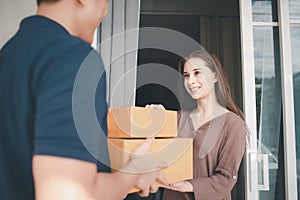 Deliver man handling package box to female costumer