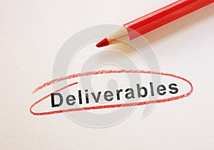 Deliverables text circled in red pencil on paper photo