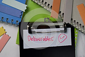 Deliverables text on paperwork isolated on office desk photo