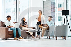 Delivering excellence through teamwork. a group of businesspeople having a discussion in an office.